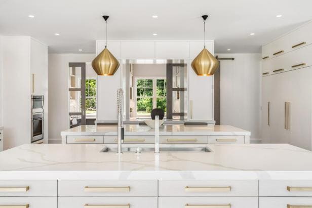 Elegance Redefined A Modern White Kitchen Adorned with Luxurious Gold Hardware
