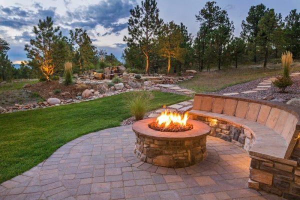 Embracing the Elements Crafting a Firepit Haven on a Sloping Landscape